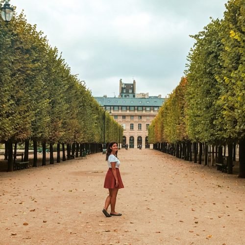 a woman standing in a garden in Paris